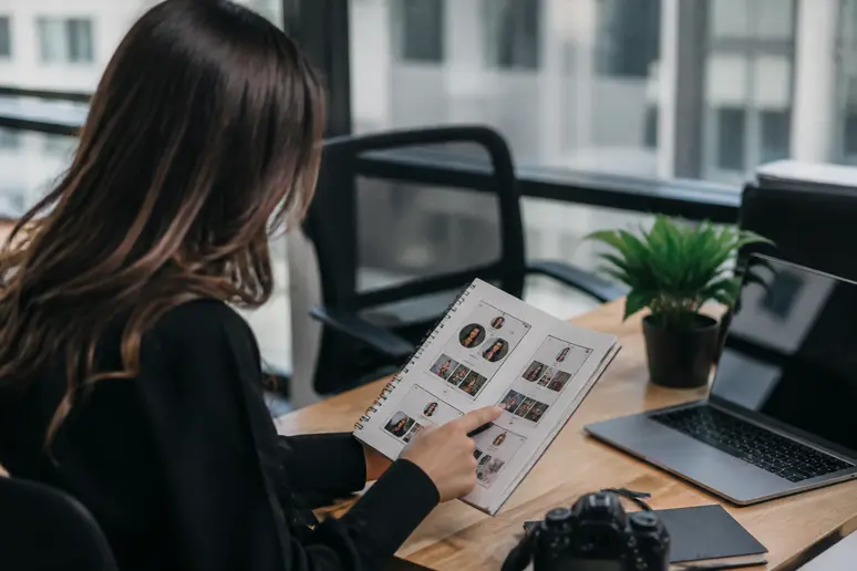 Digital strategist reviewing profile field limits and copy adjustments on a desk