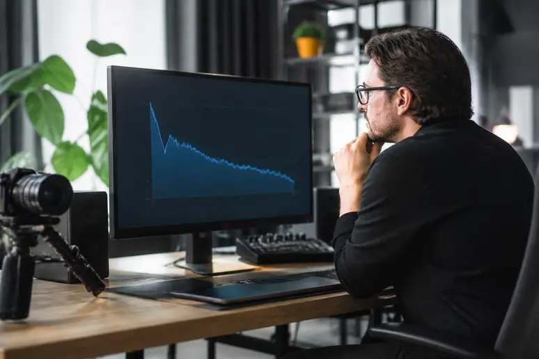 Creator analyzing YouTube audience retention graphs to track average percentage viewed.