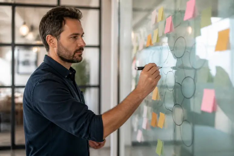 Professional marketer mapping semantic keywords and sales copy on a whiteboard during strategy planning