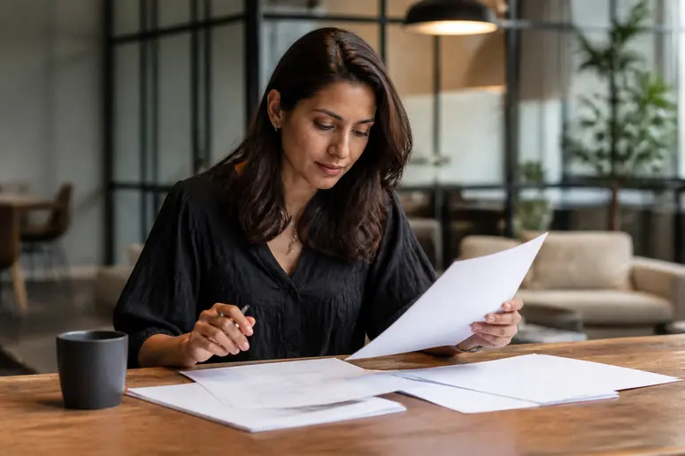 Digital marketing strategist reviewing structured SEO proposal template components on a wooden table