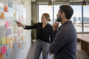 Marketing professionals analyzing buyer intent and types of SEO keywords on a whiteboard in Denver