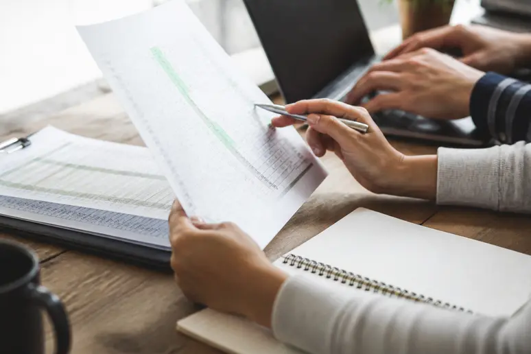 Developer reviewing redirect mapping spreadsheets during SEO website migration checklist planning