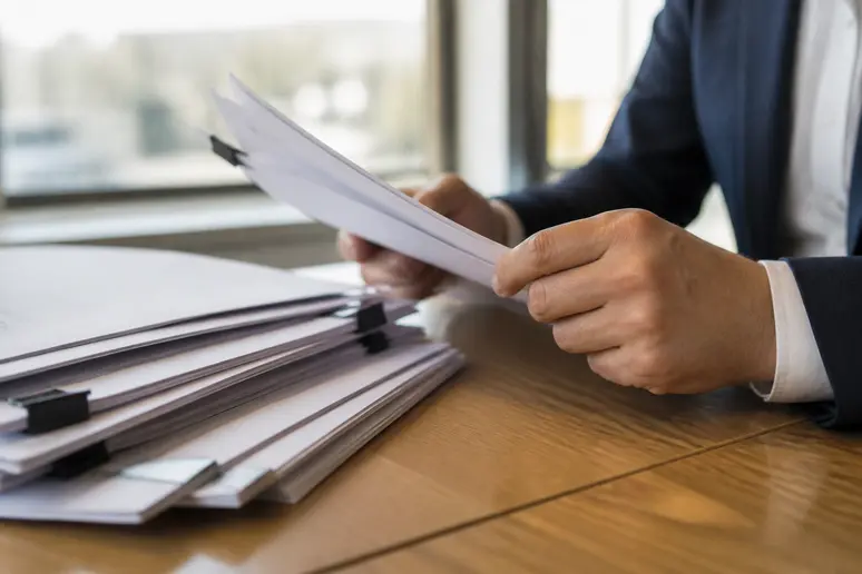 Telecom administrator reviewing carrier transfer documents for business phone porting